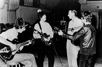 Publicity photo of the Beatles with producer G...
