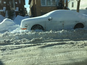 Parked car left covered in snow by its owner. The snow freezes and is hard to remove after 3 days.