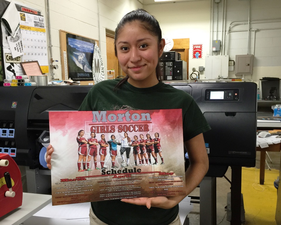 Alma Lara (Morton West, Class of 2017) with her design. “I wanted the Girls Soccer poster to look strong, because in the picture they represent ‘bold.’ They’re strong, they’re going for it.”