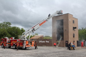 Participants at the Orland Fire Protection DIstrict's Annual Kid’s Fire & Life Safety Camp observe firsthand how firefighters battle fires