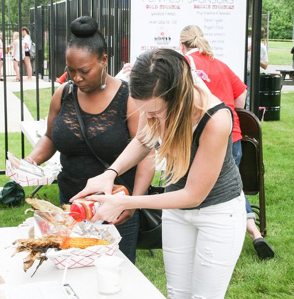 Tasty Treats: A young lady adds her favorite condiments on her food. Photos Copyright (C) Steve Neuhaus 2015. All Rights Reserved. Permission to reprint with full attribution to Steve Neuhaus and the Illinois News Network..