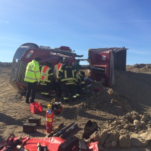 Orland Fire Protection District emergency responders work to extricate a driver pinned in the cabin of his overturned truck on La Grange Road in Orland Park Saturday Oct. 10, 2015