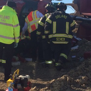 Orland Fire Protection District emergency responders work to extricate a driver pinned in the cabin of his overturned truck on La Grange Road in Orland Park Saturday Oct. 10, 2015