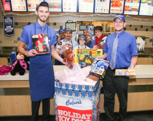 Culvers Manager poses with Toys collected in fundraiser for needy children. Photo Copyright (C) 2015 Steve Neuhaus All Rights Reserved