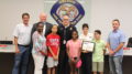 From left OFPD Trustee Blair Rhode, Trustee John Brudnak, Cortez’s mother, Cortez, Fire Chief Michael Schofield, Cortez’s sister Taylor, Sgt. Cindy Guerra, Cindy’s son Joseph, and OFPD Trustee Jim Hickey.