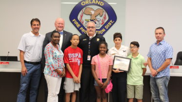 From left OFPD Trustee Blair Rhode, Trustee John Brudnak, Cortez’s mother, Cortez, Fire Chief Michael Schofield, Cortez’s sister Taylor, Sgt. Cindy Guerra, Cindy’s son Joseph, and OFPD Trustee Jim Hickey.