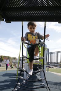 Children play at the new Cicero Campus Park on state-of-the-art equipment